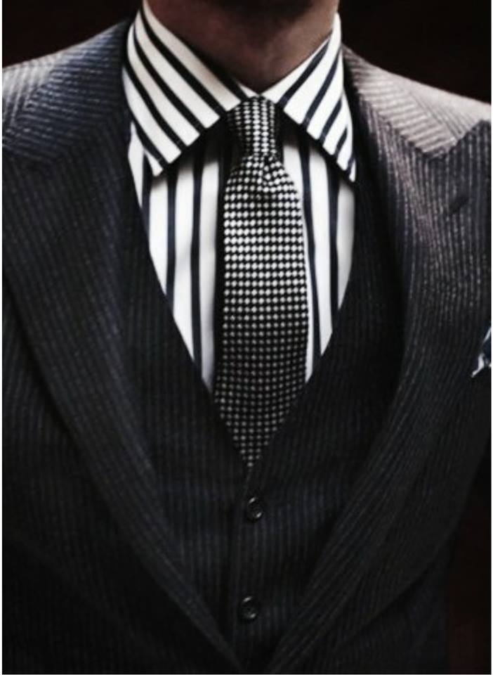 A man in a suit and tie with a striped shirt
