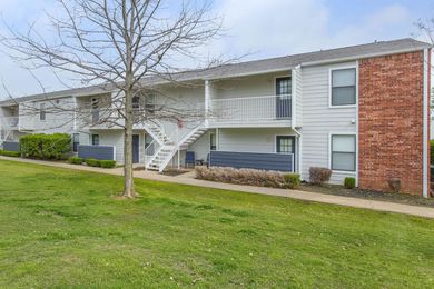 A large apartment building with stairs leading up to the second floor at Rena Valley in Van Buren, AR.