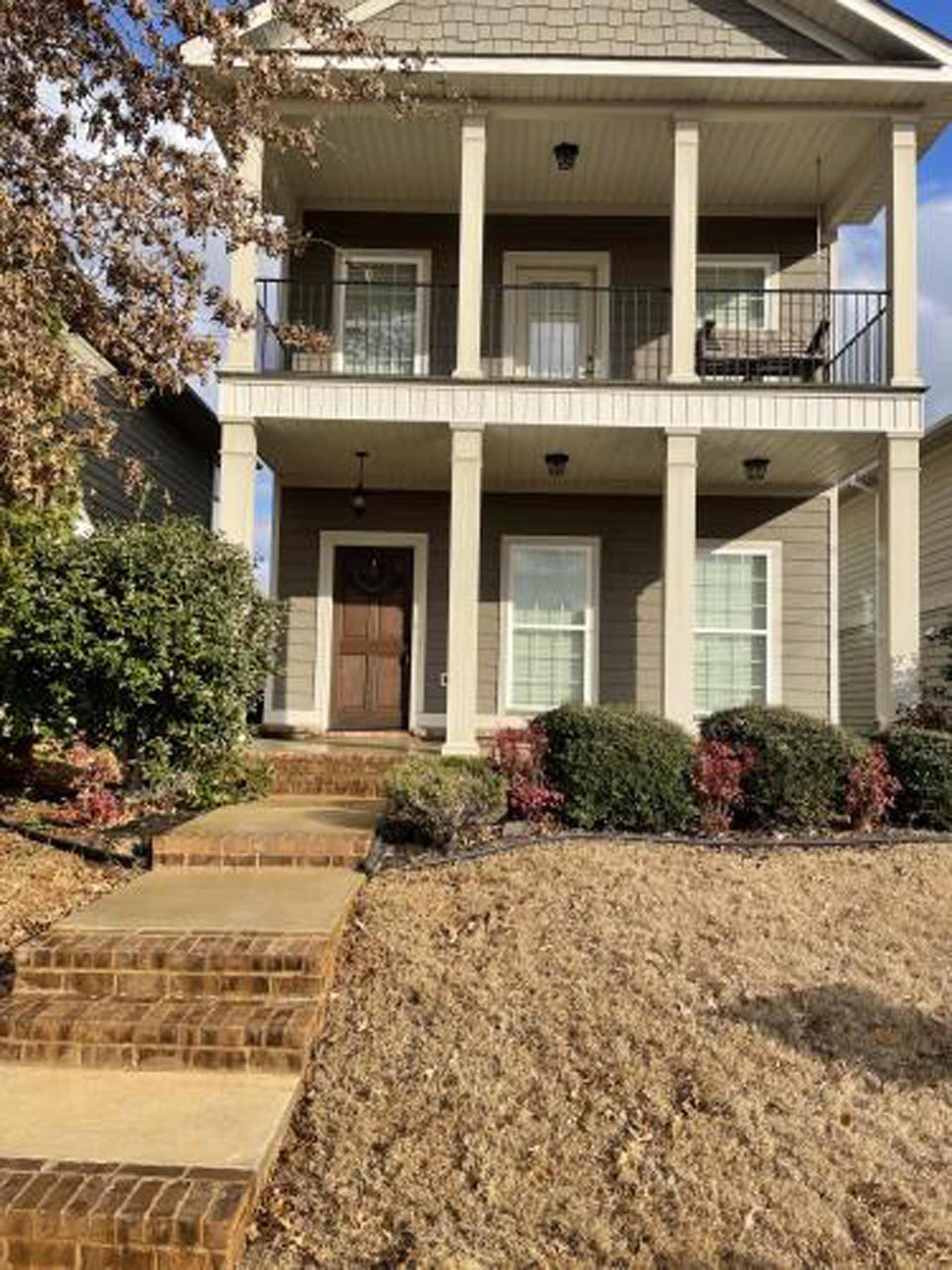 A large house with a large porch and stairs