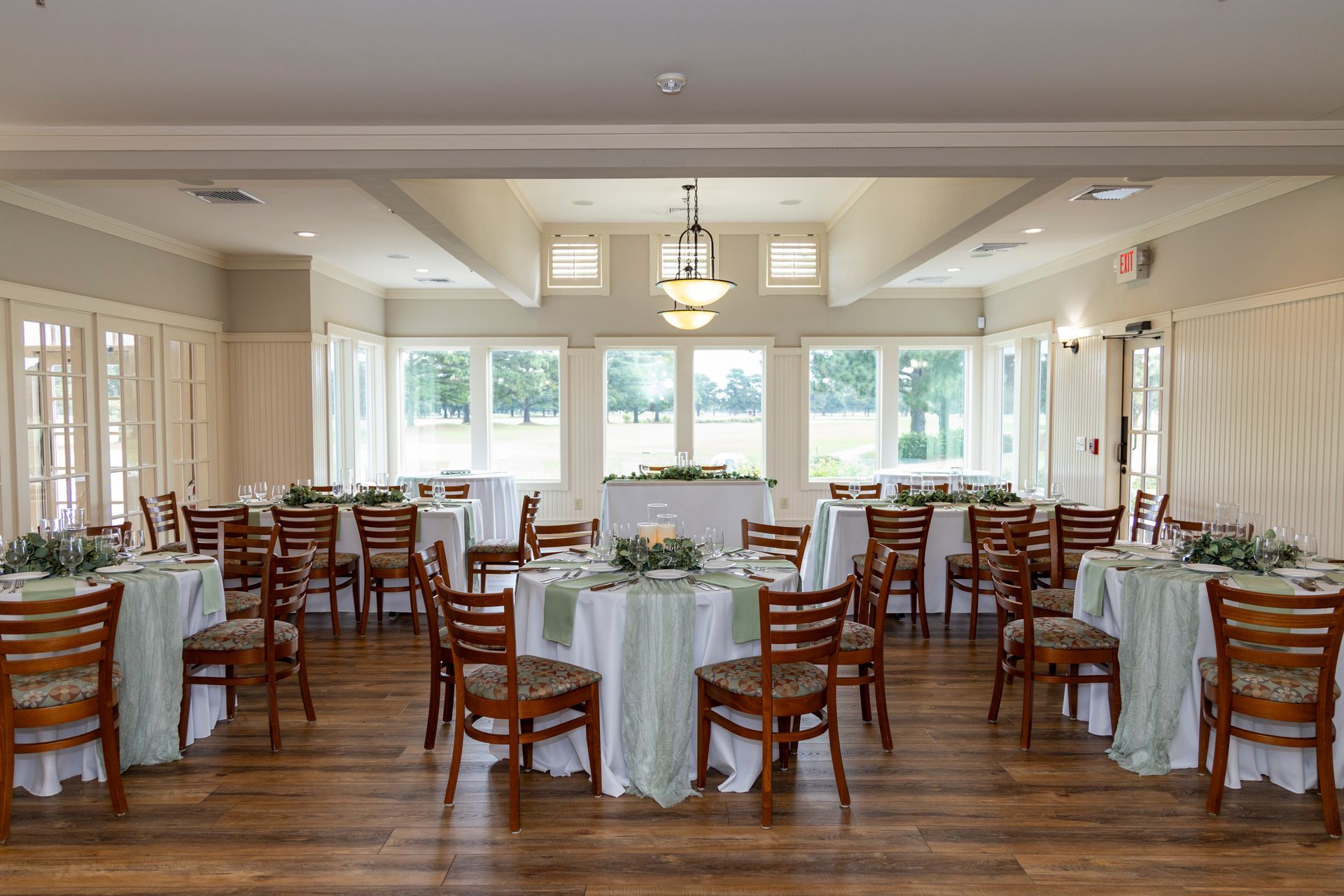 Beautiful reception table settings at The Pointe Golf Club overlooking #9 green 