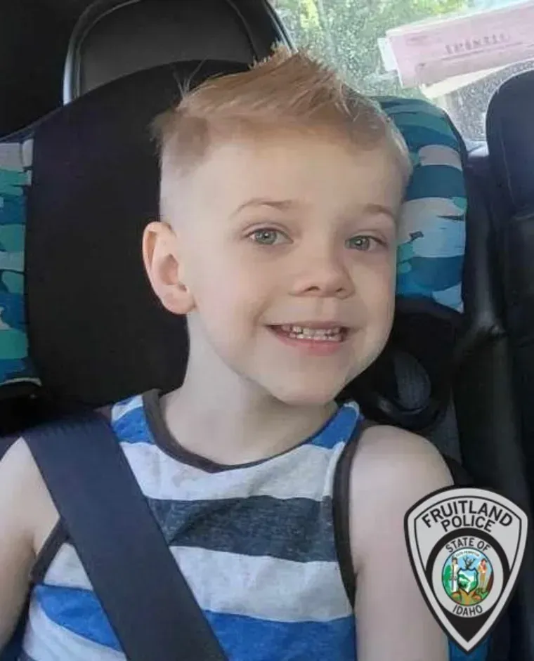 A smiling child in a striped tank top sits in a car seat, with a Fruitland Police badge overlaid in the corner.
