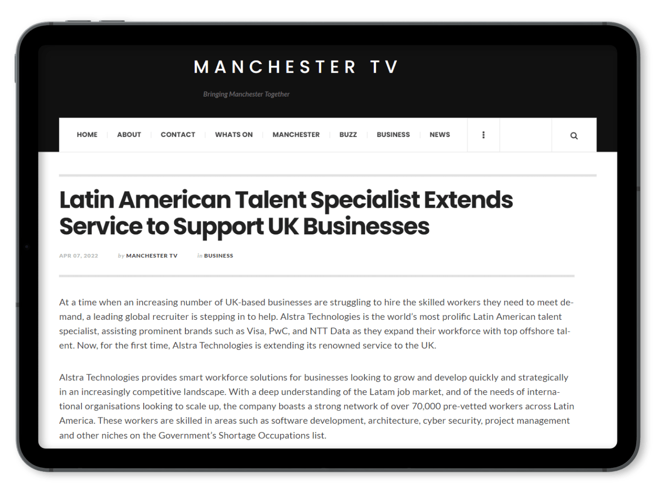 A tablet screen shows a news article about latin american talent specialist extending service to support uk businesses.