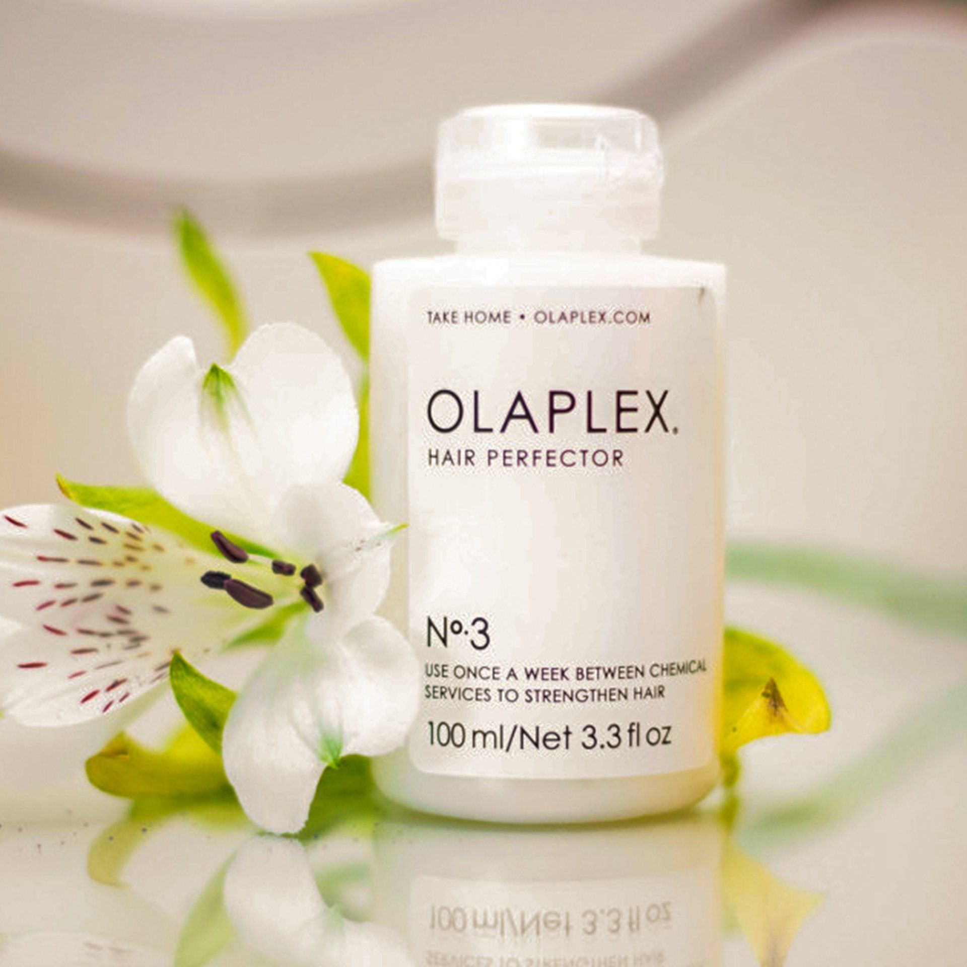 A white bottle of olaplex hair perfector no 3