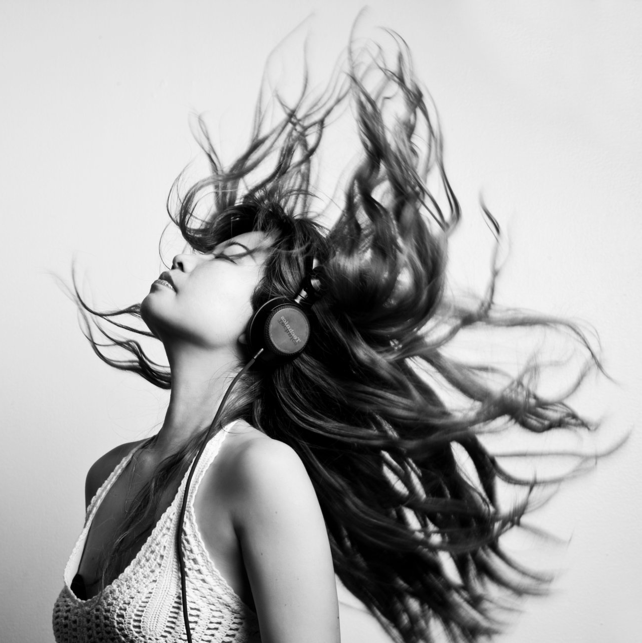 Woman with head back wearing headphones with long flowing hair - Revive Hairdressing Hairdressers - The Palms, Shirley, Christchurch