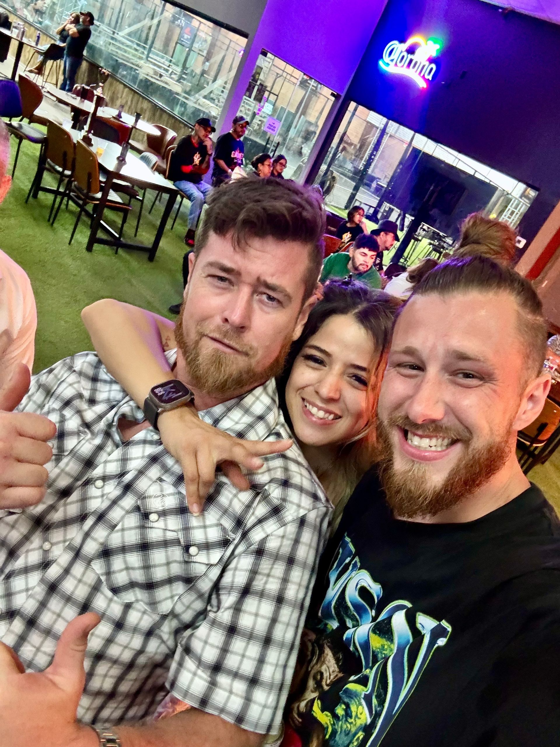A margarita with a red rim and a lime wedge on a table.