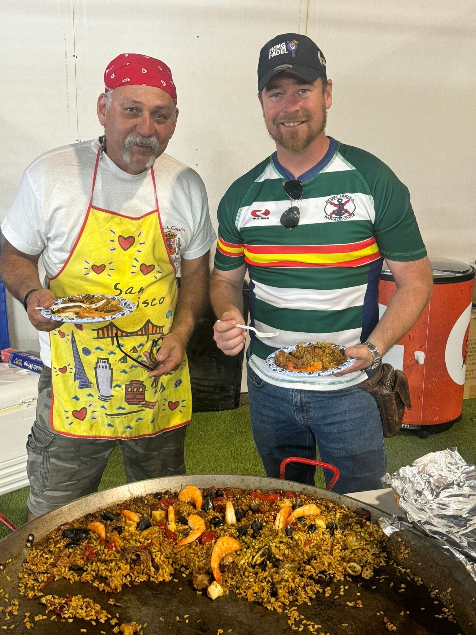 A group of men standing next to each other holding tennis rackets