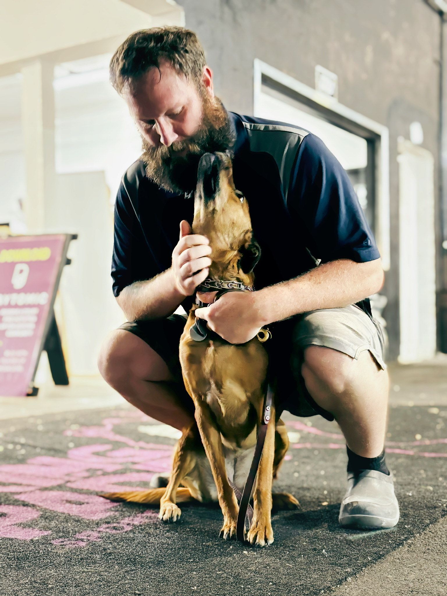 A man and a woman are sitting on yoga mats in a gym.