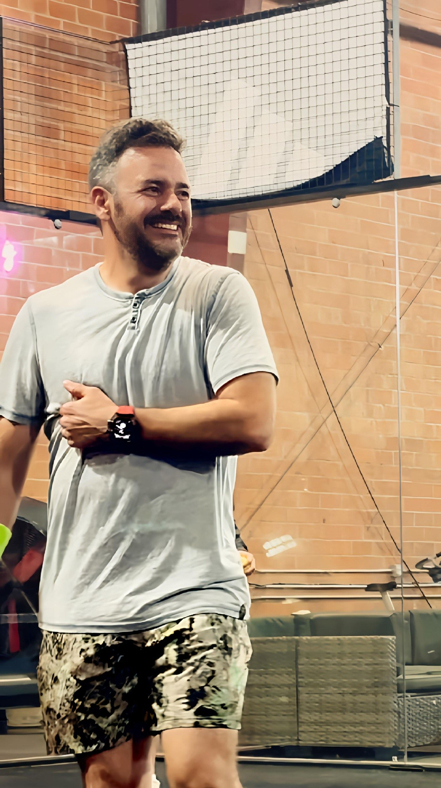 A man and a woman are sitting on a purple mat with dumbbells and a ball