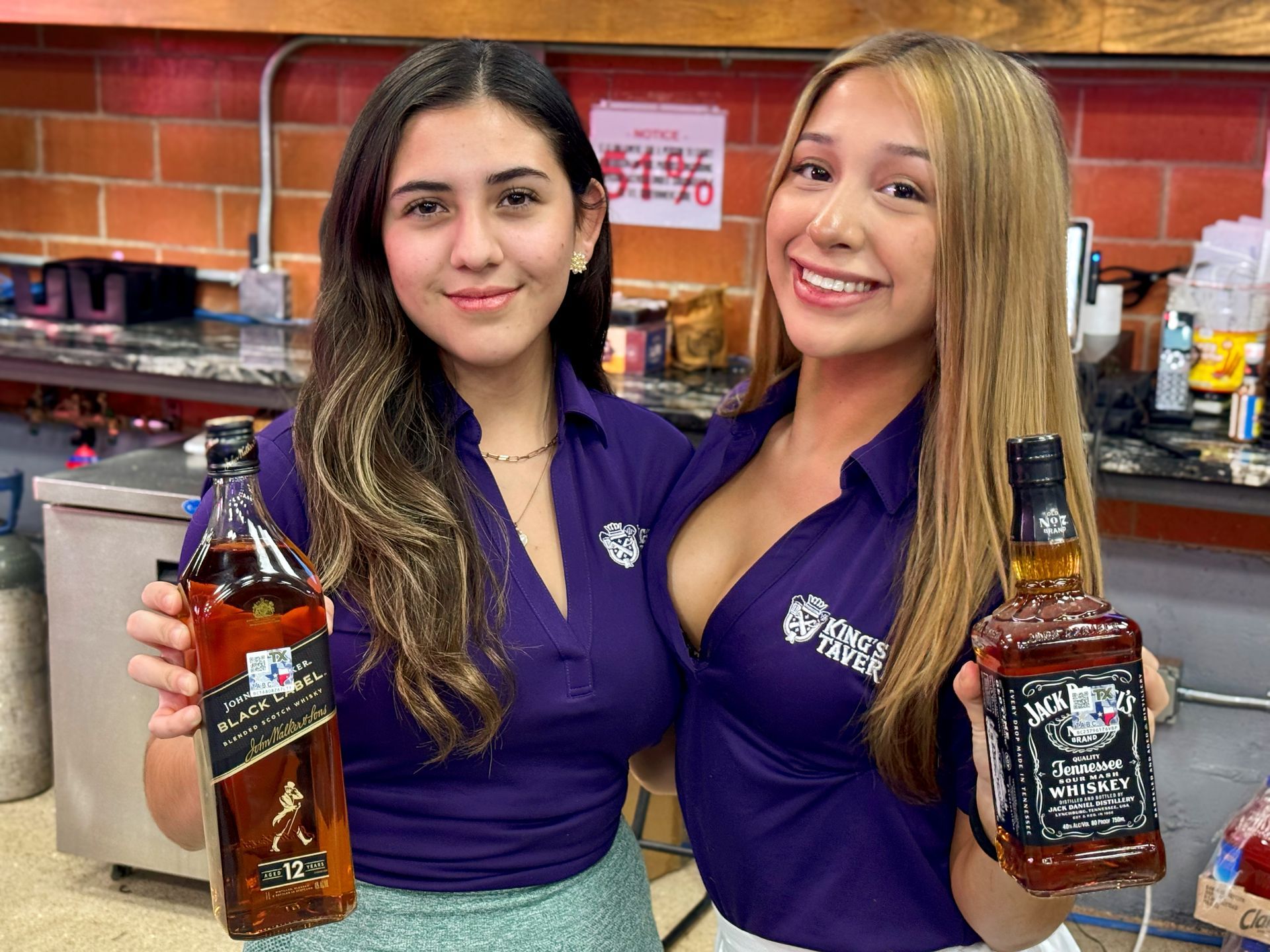 A person is holding a hot dog in front of a neon sign that says king padel