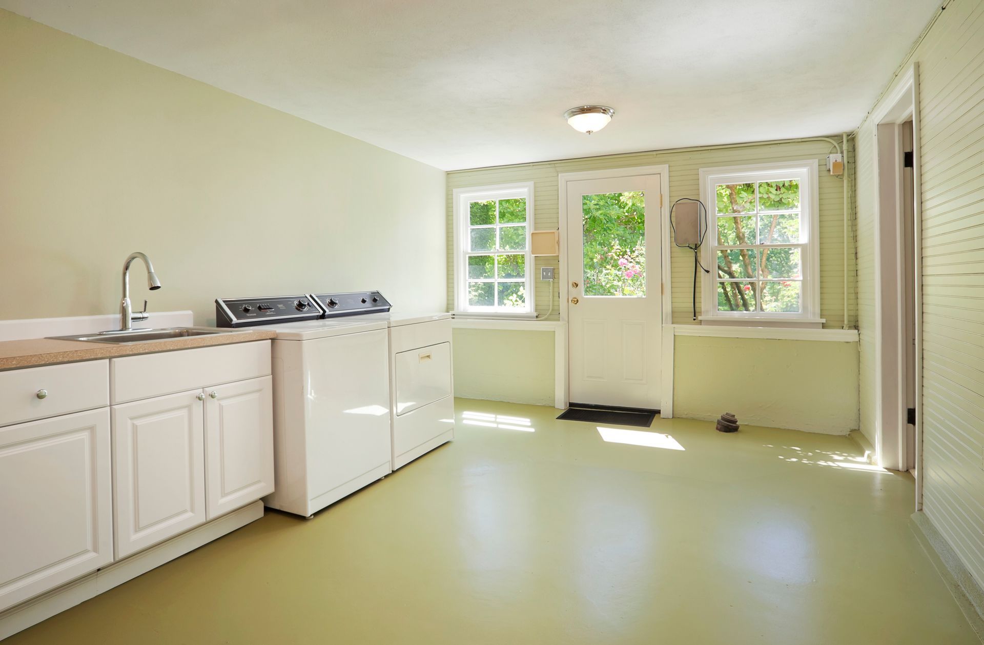 What To Expect During Bathroom Remodeling — Nyack, NY — FWS Home Improvement A laundry room with a washer and dryer and a sink.