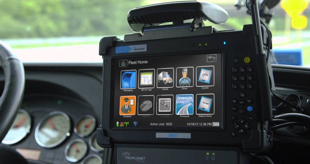 Dashboard mounted touchscreen displaying icons, inside of a vehicle.