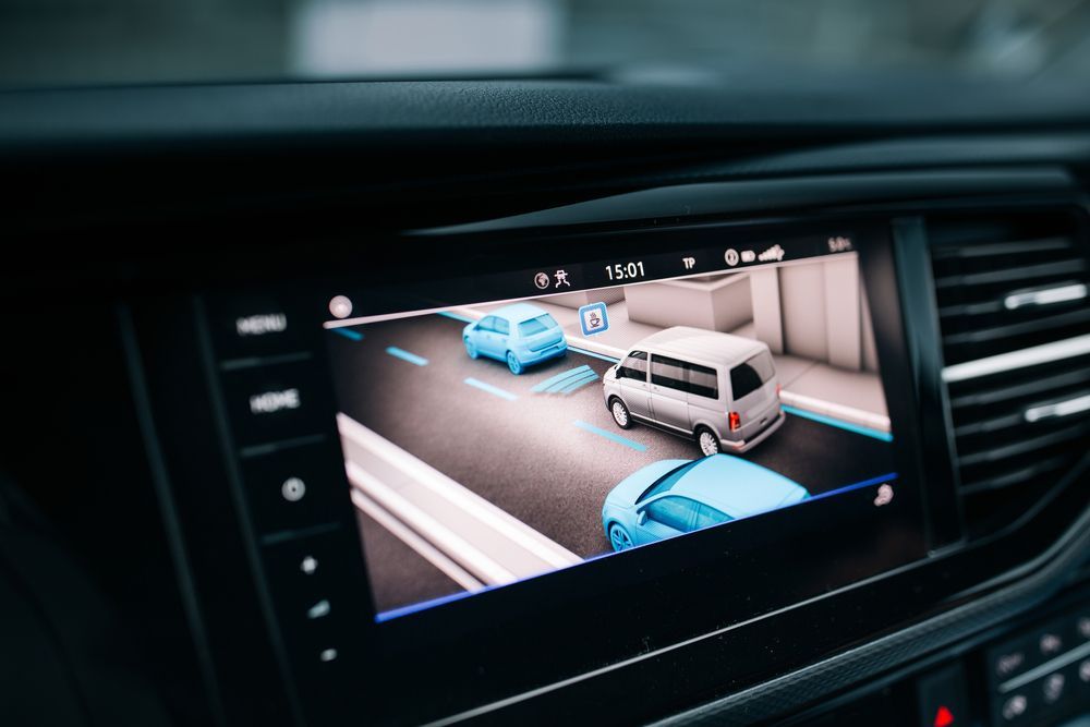 A car dashboard with a rear view camera on it.