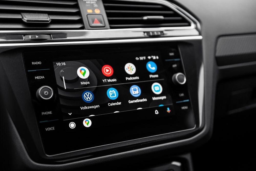A close up of a car radio with a lot of apps on it.