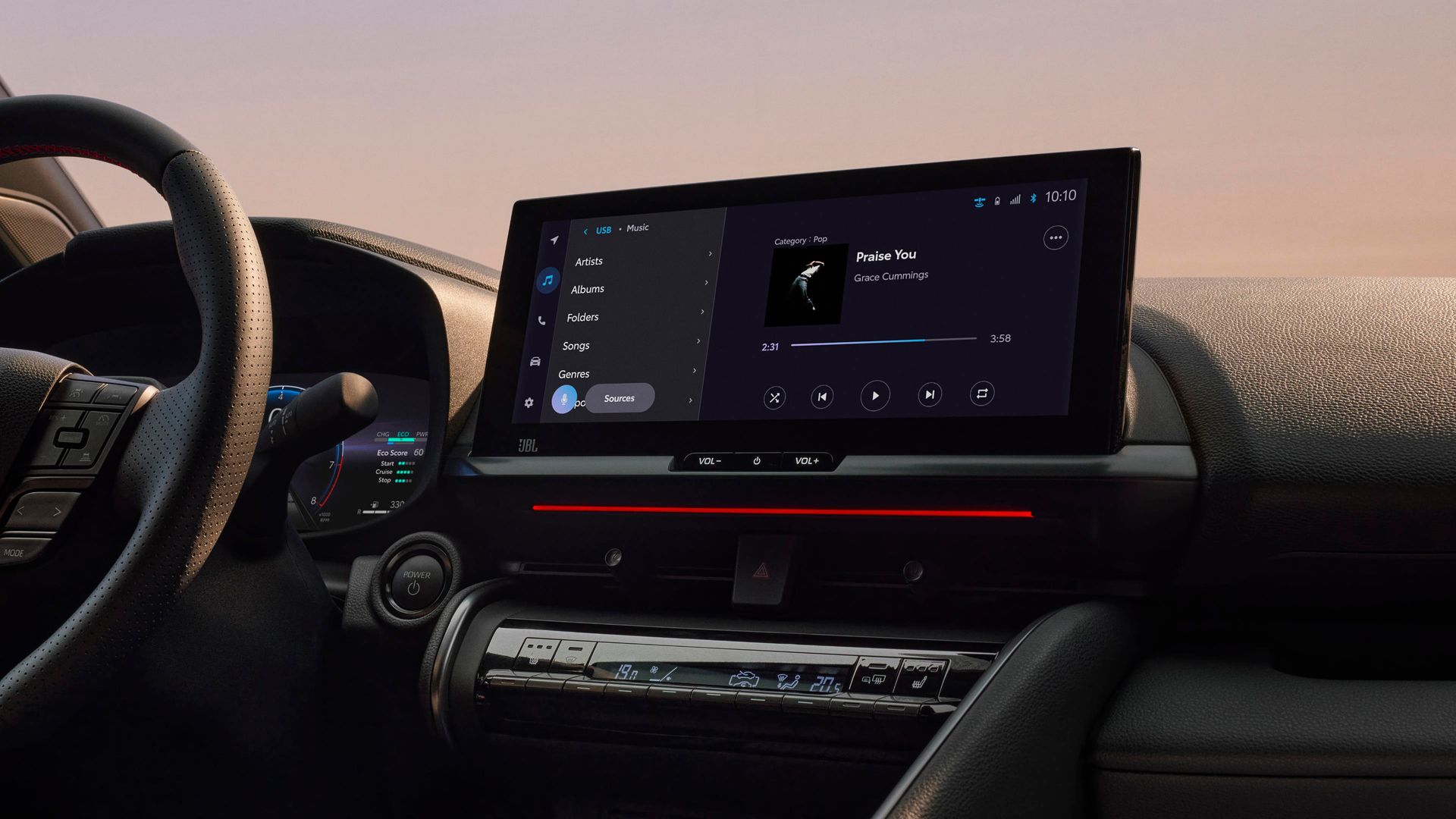 A car dashboard with a steering wheel and a touchscreen display.