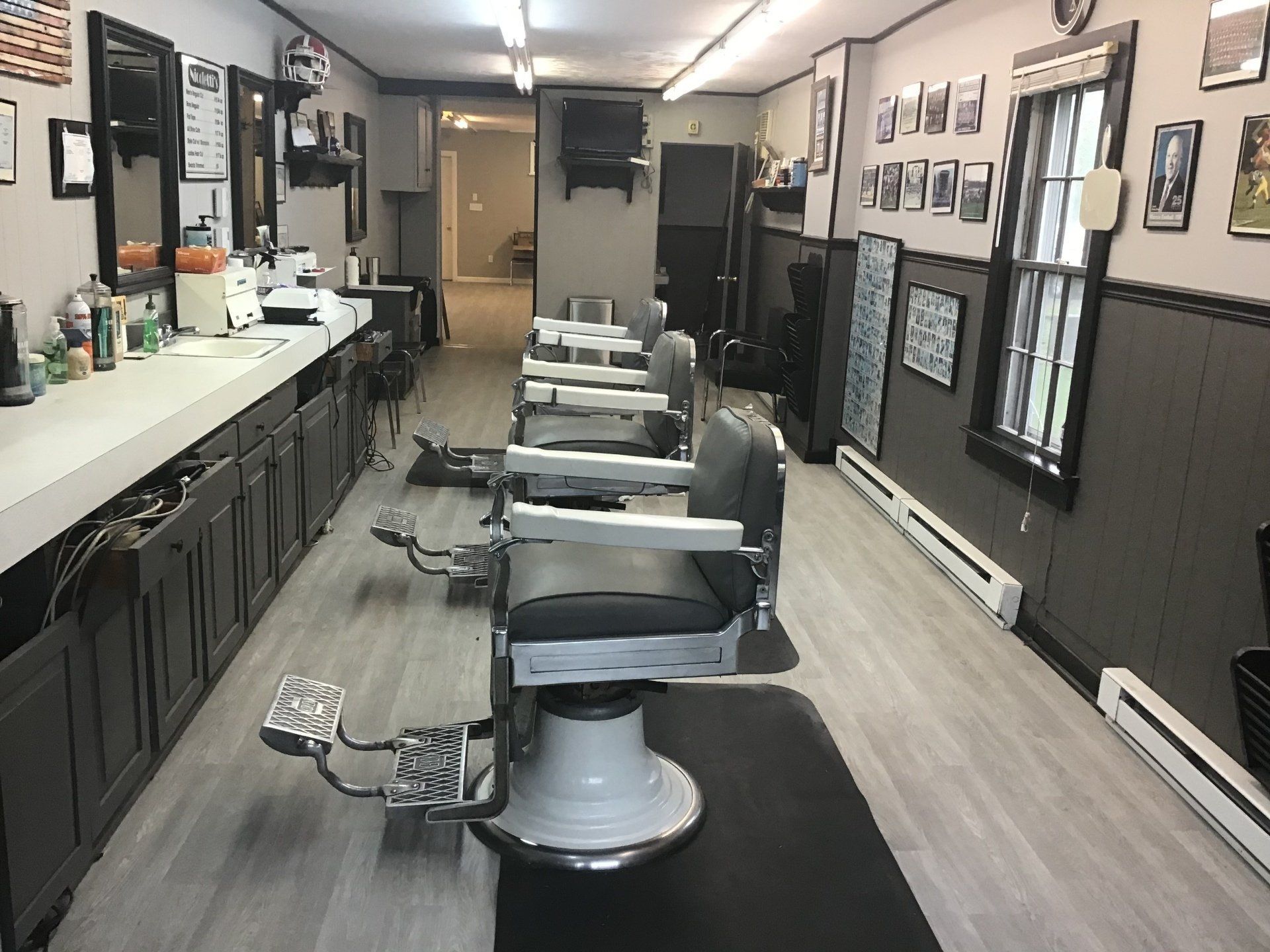 A barber shop with a lot of chairs and mirrors