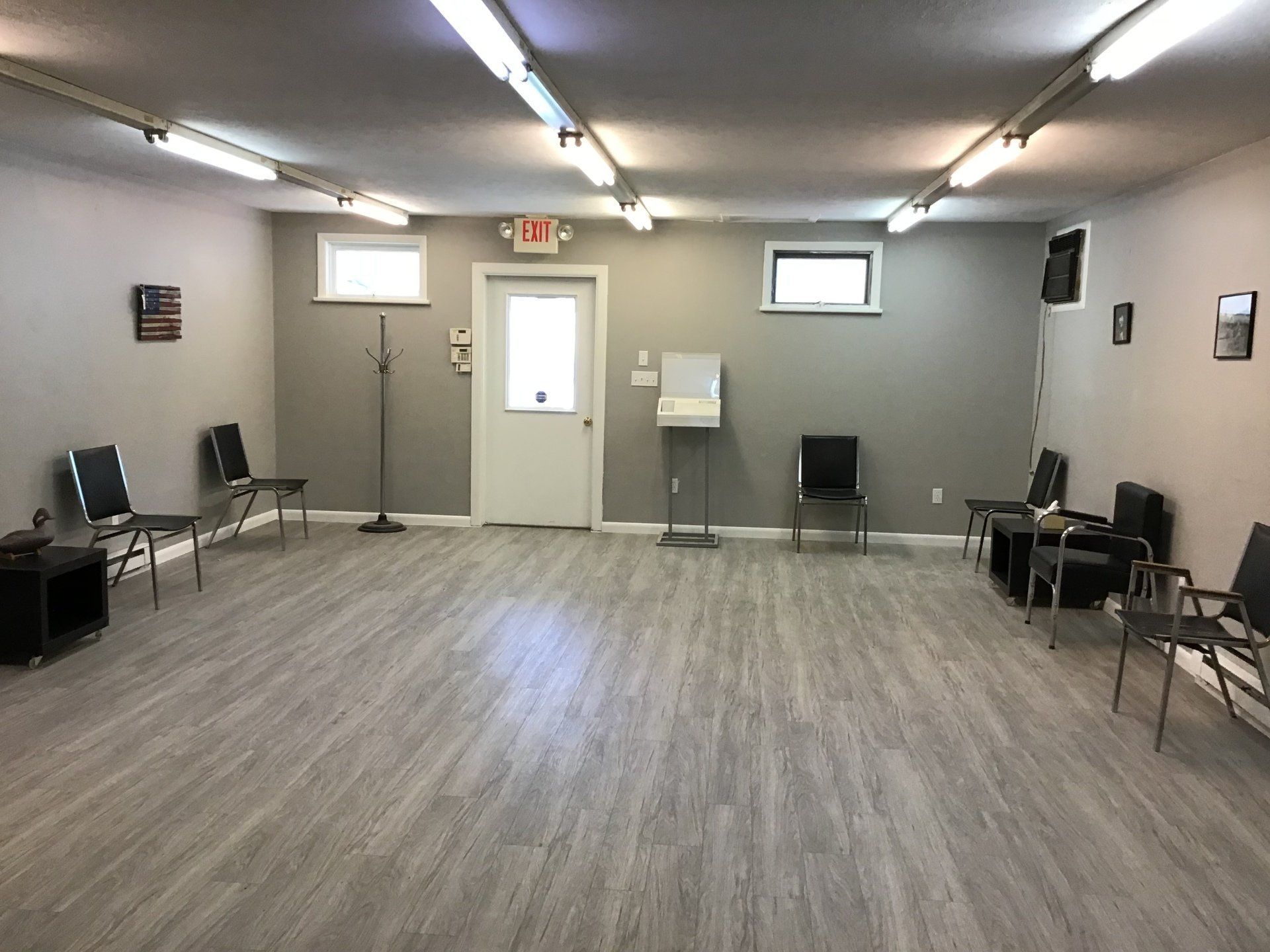 A room with a lot of chairs and a door