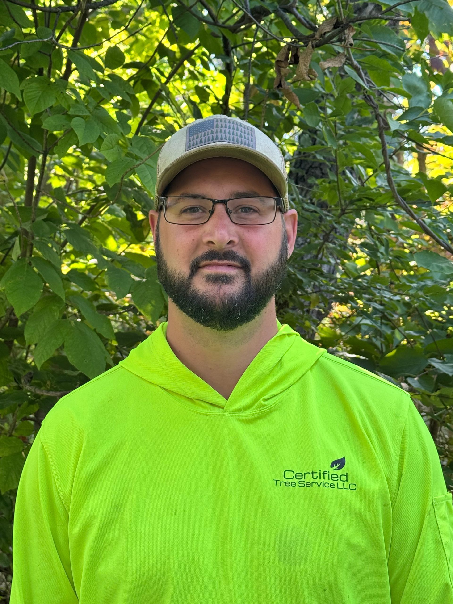 A man is taking a selfie in the back seat of a car