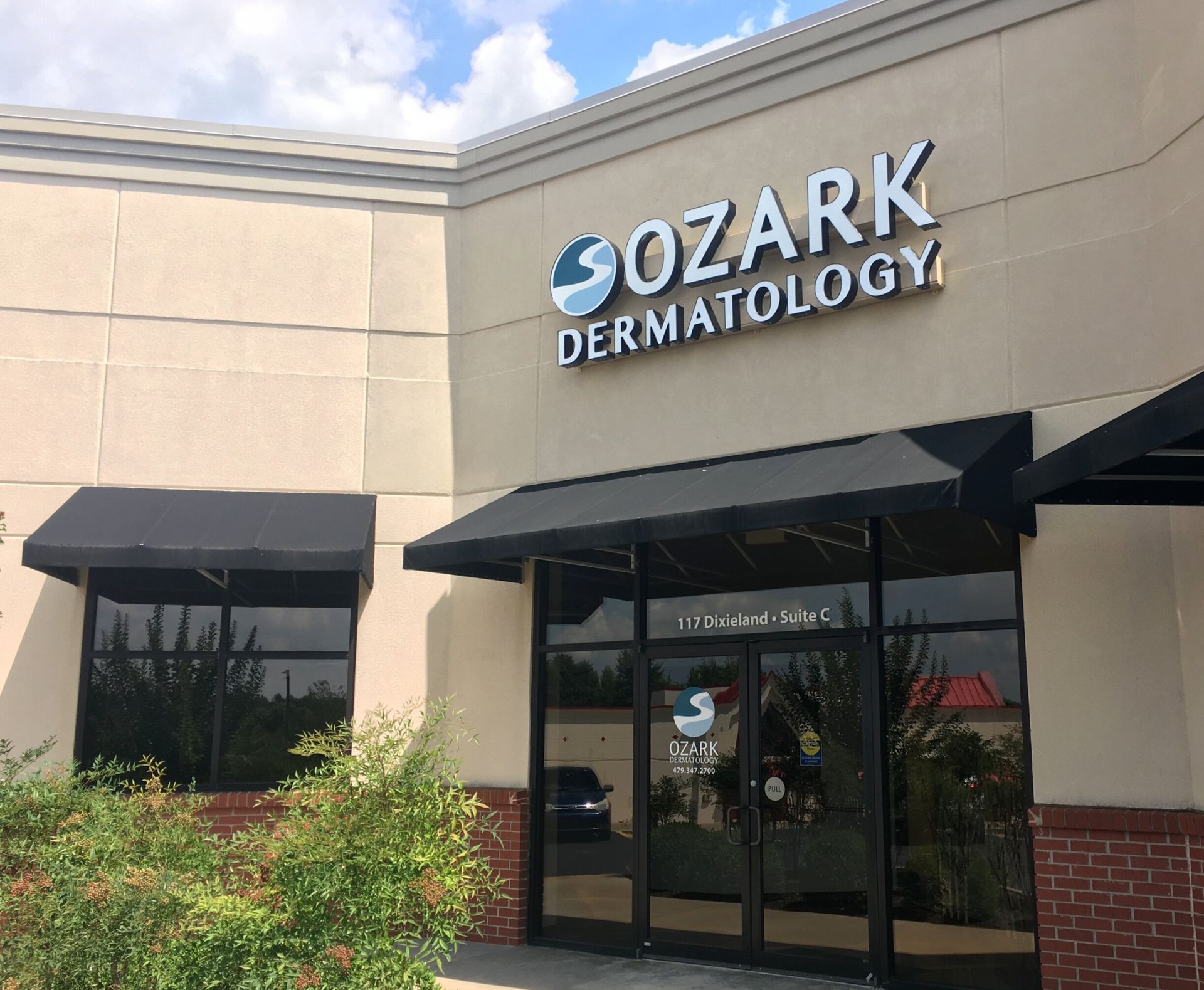 A building with a sign that says sozark dermatology