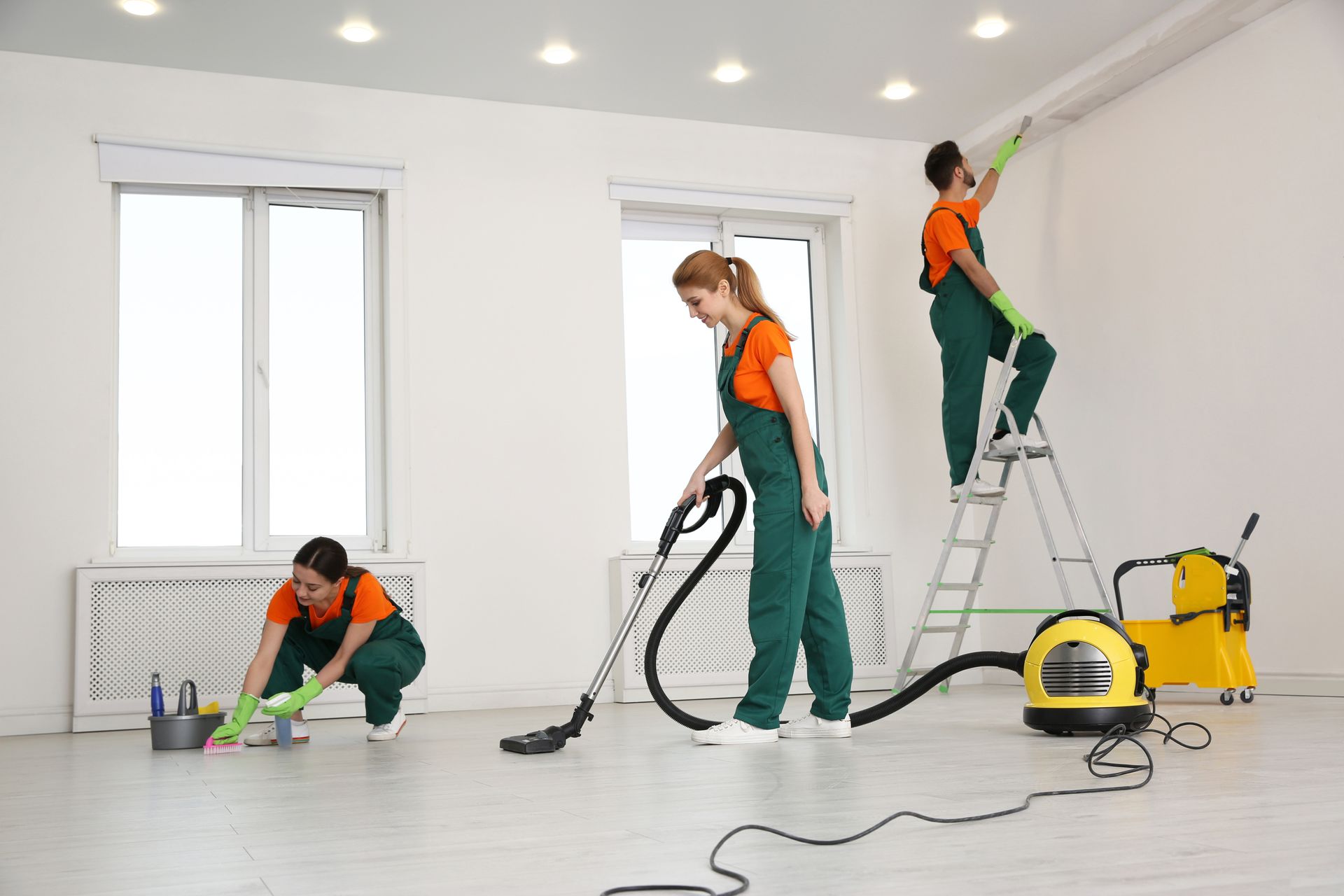 A group of cleaners are cleaning a room.