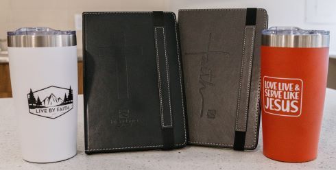 A red tumbler with the word jesus on it