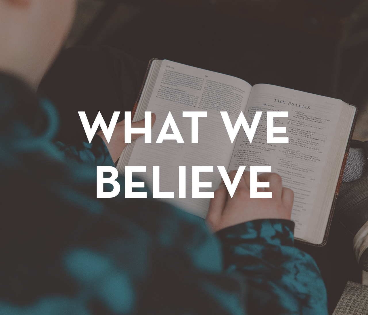 A person is reading a bible with the words `` what we believe '' above them.