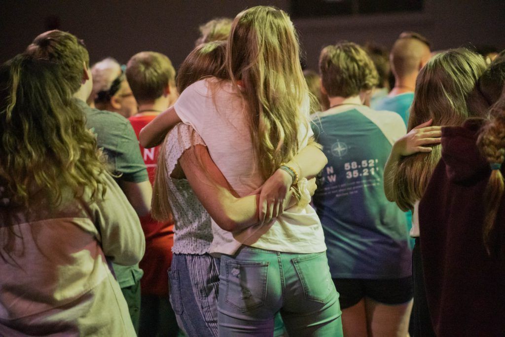 A group of people are hugging each other in a circle.