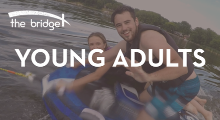 A man and a girl are riding a jet ski in the water.