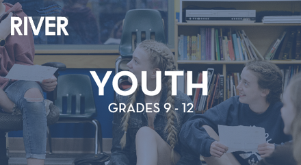 A group of young people are sitting in a library.