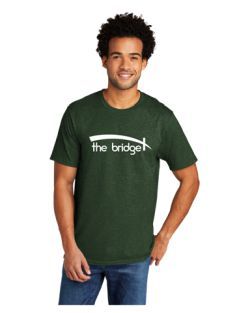 A man wearing a green t-shirt that says the bridge