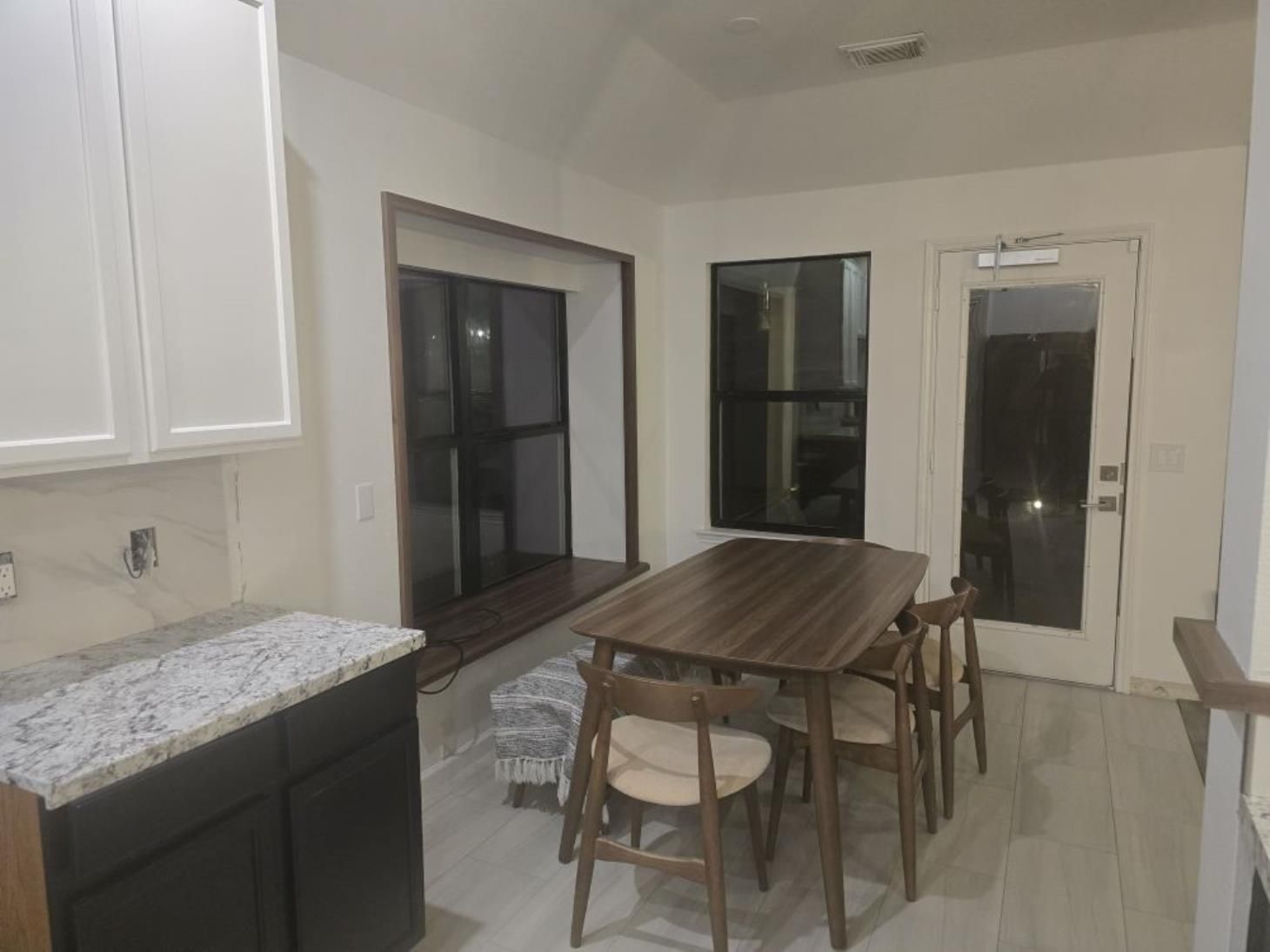 A person using a vacuum cleaner to clean a mattress, effectively removing dust, dirt, and allergens.
