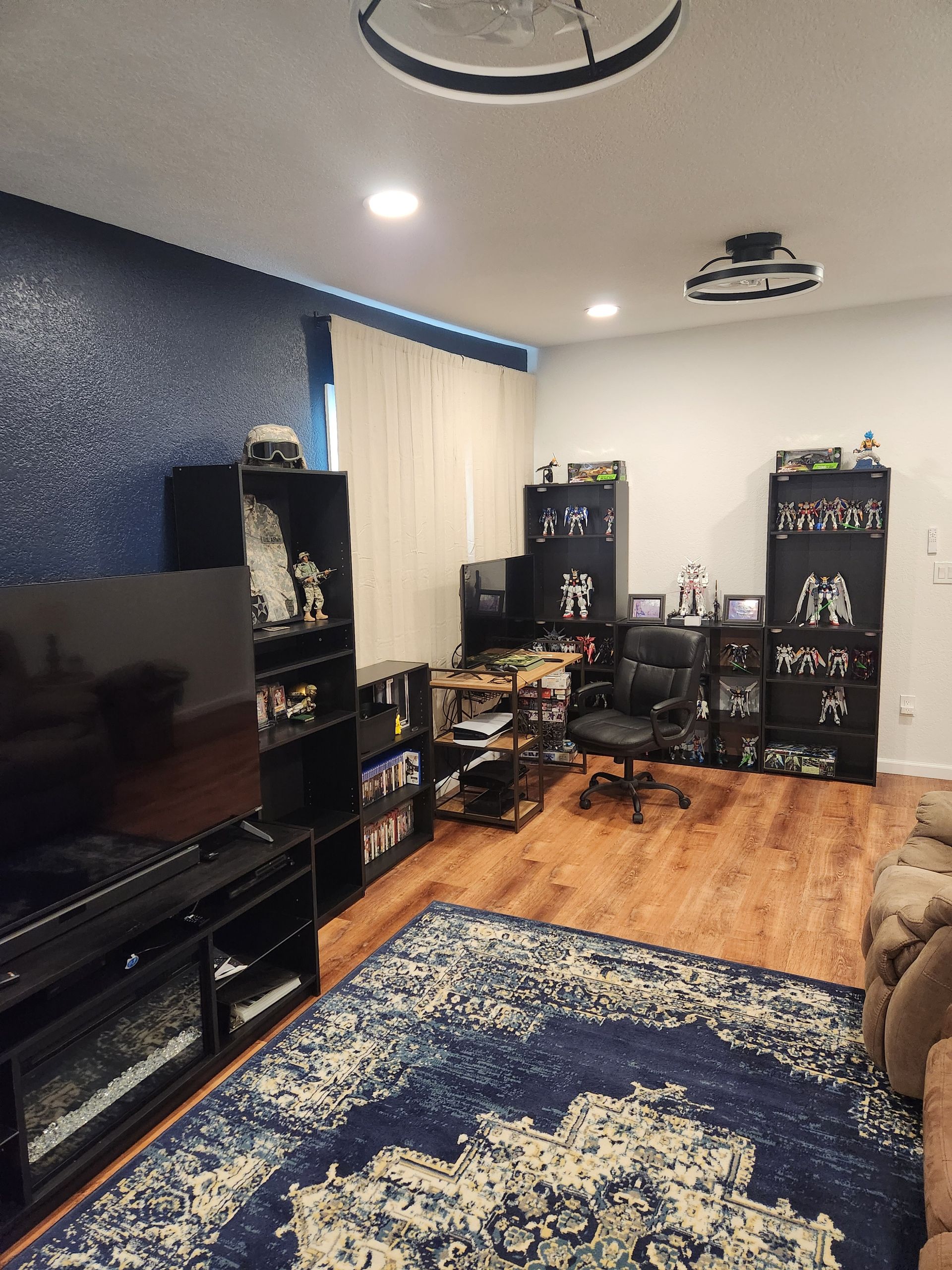 Construction worker using a tool to work on a column, inside a building under construction, red ladder present.