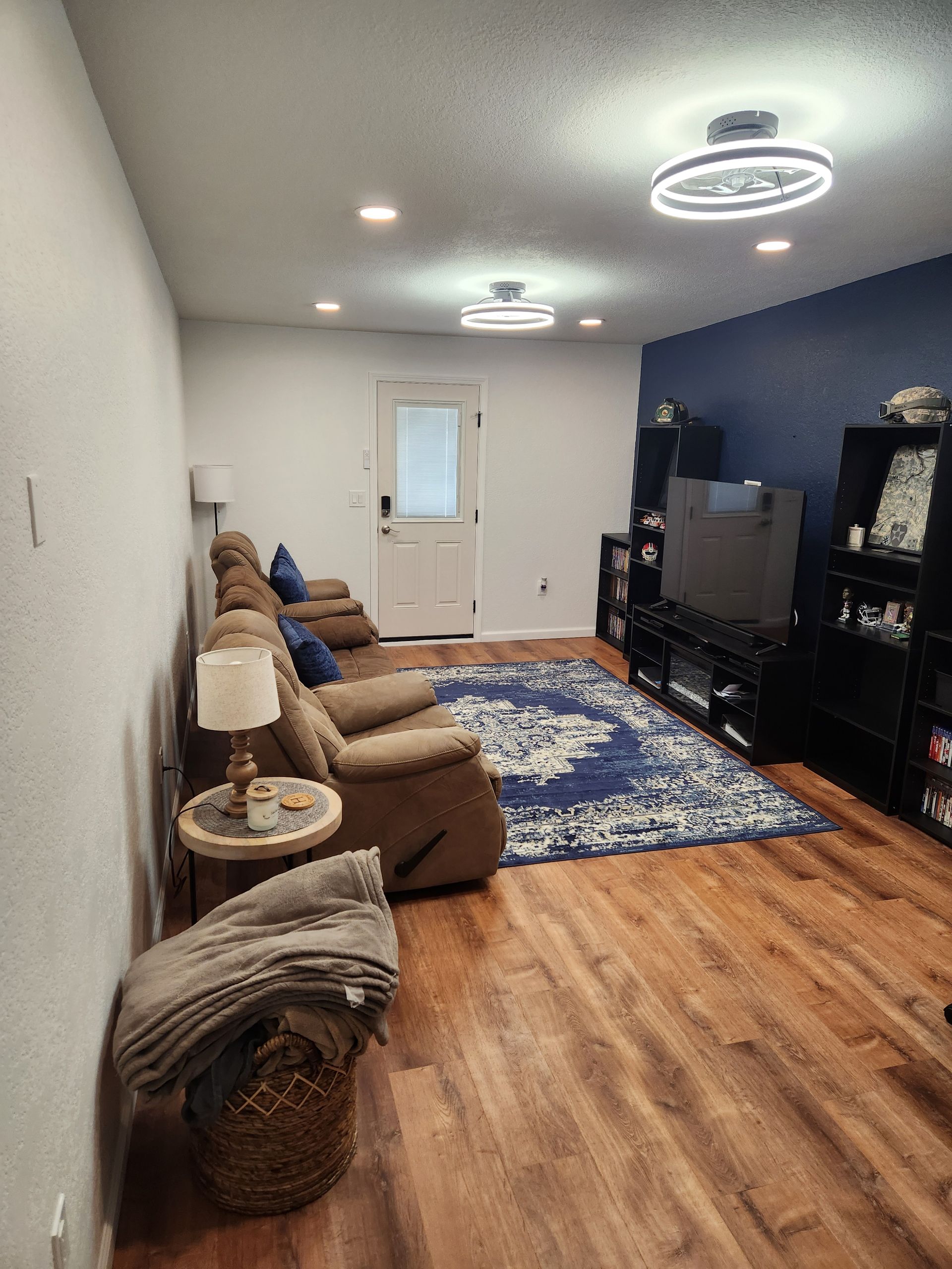 Room being painted with roller; floor and walls changing color.