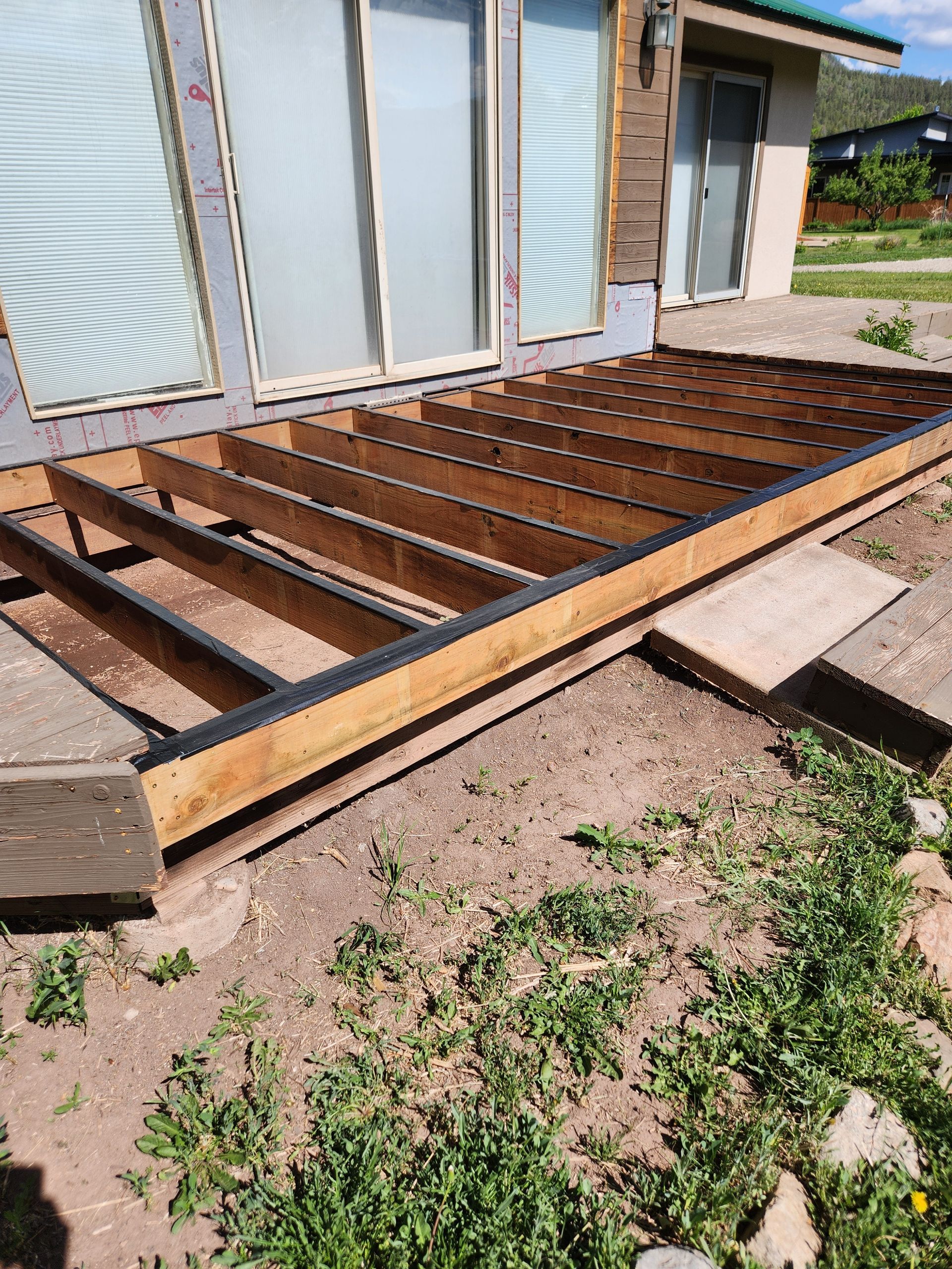 Newly renovated kitchen with white cabinets, wood floors, and unfinished island.