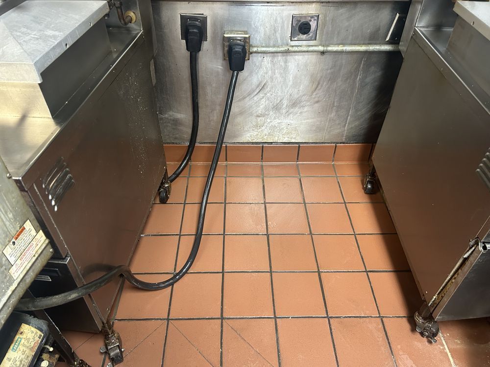 A kitchen with a tile floor and stainless steel appliances