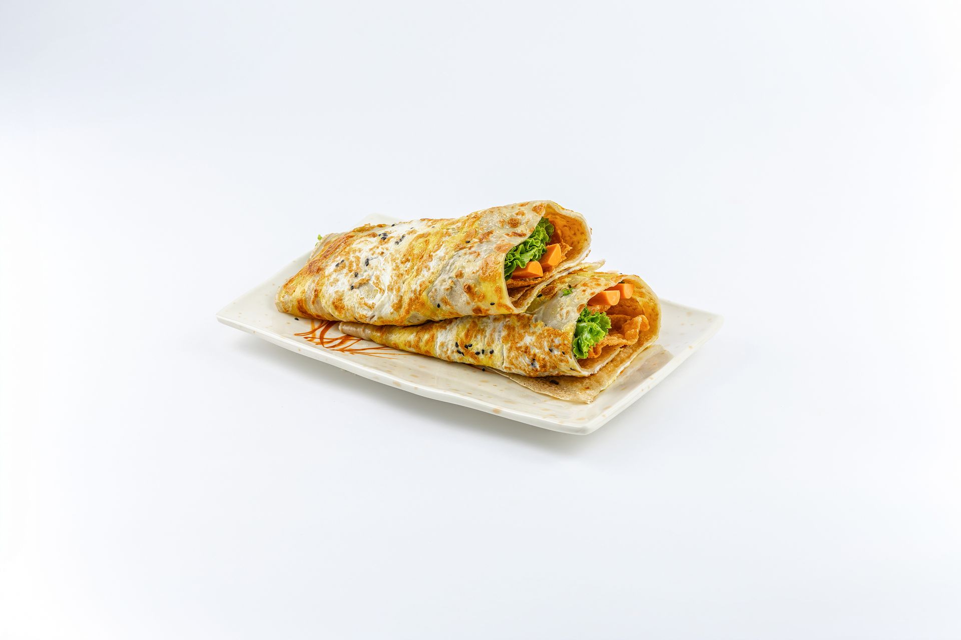 Two savory vegetable wraps served on a rectangular white plate against a plain white background.