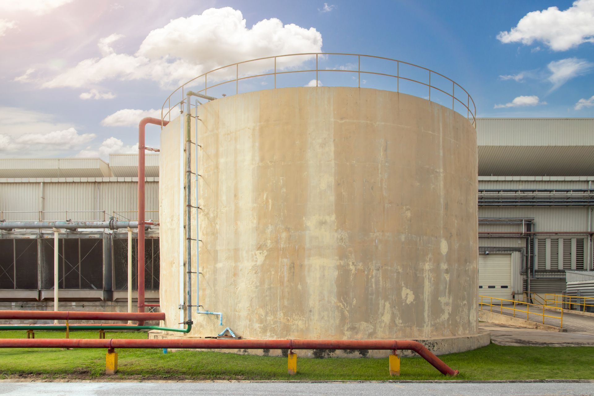 View of a concrete water tank in an industrial site.