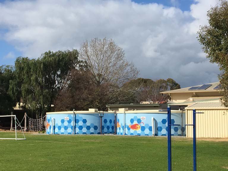 A Soccer Field With A Building In The Background – Perth, WA - Armadale Concrete Tank Co.