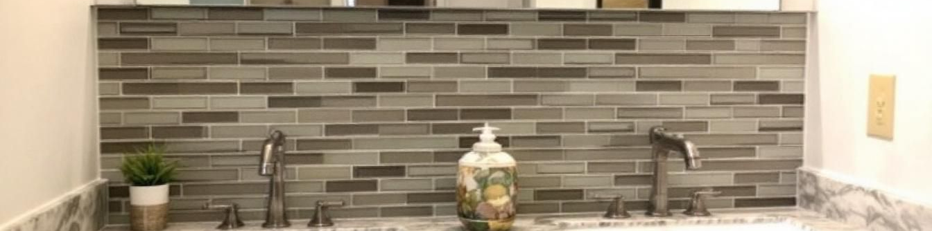 Bathroom tile backsplash with two sinks.
