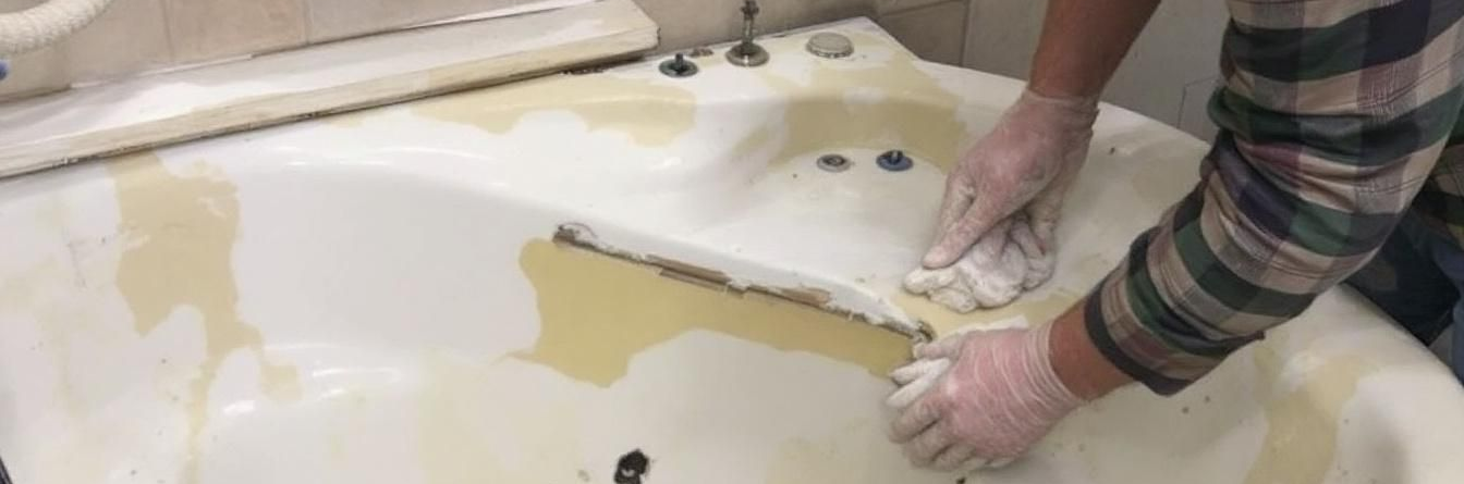 Tub being torn out for removal.