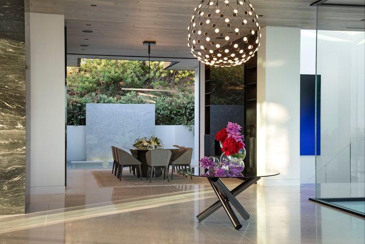 A dining room with a table and chairs in it