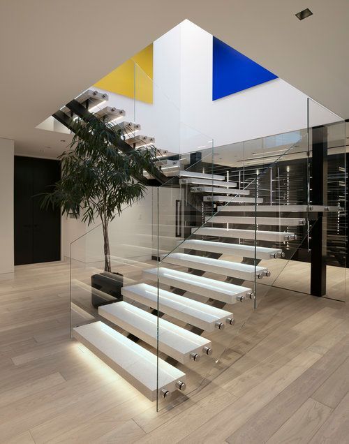 A staircase with white steps and a glass railing