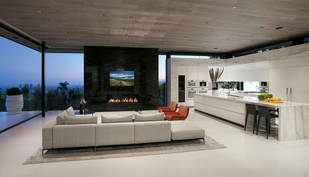 A living room with a couch , fireplace and television.