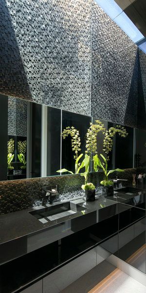 A bathroom with two sinks and a large mirror.
