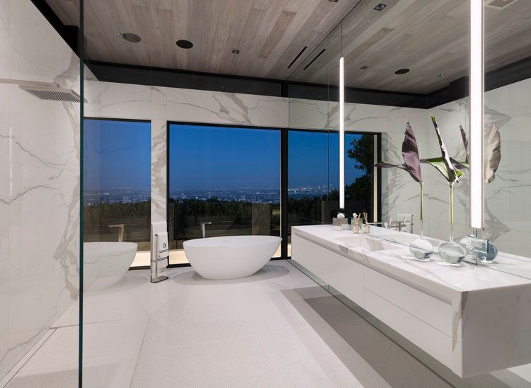 A bathroom with a bathtub and two sinks