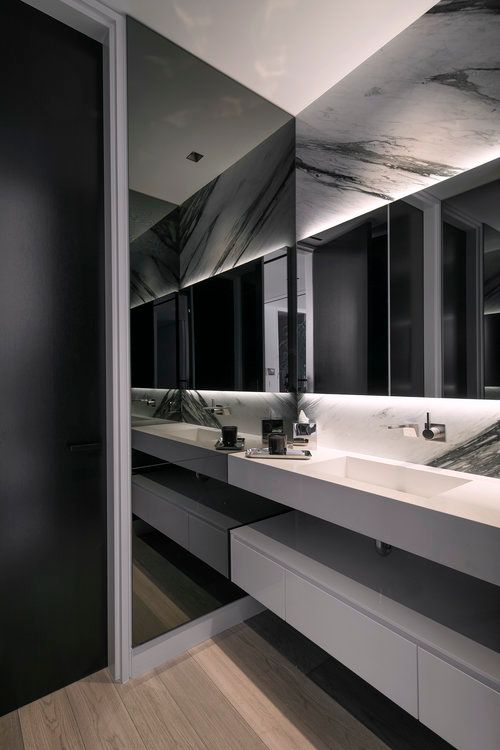 A bathroom with two sinks and a large mirror