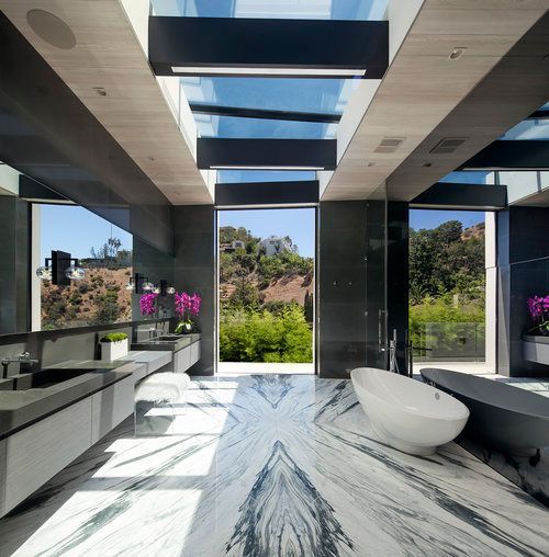A bathroom with a marble floor and a bathtub