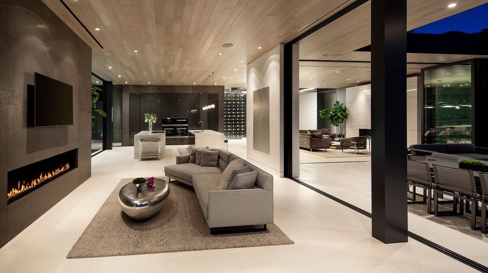 A living room with a couch , fireplace and television.