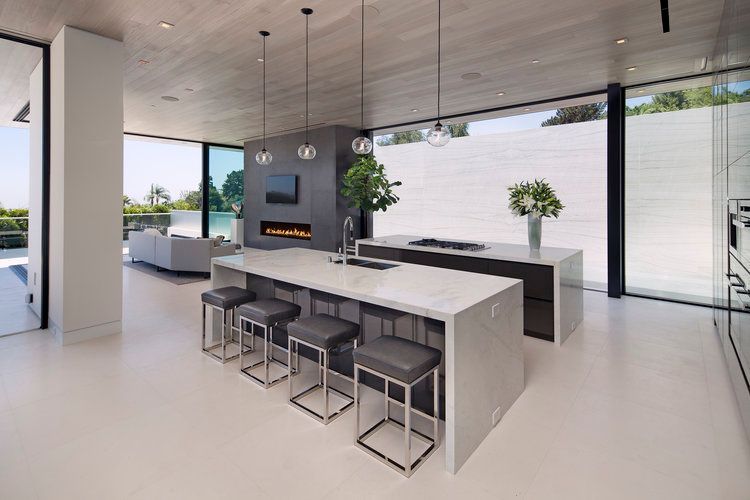 A modern kitchen with a large island and stools