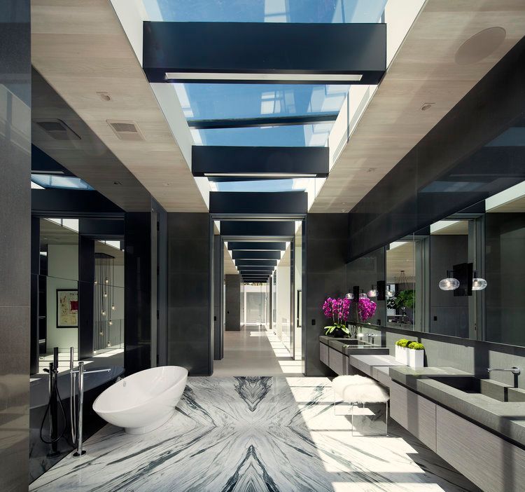 A bathroom with a marble floor and a bathtub