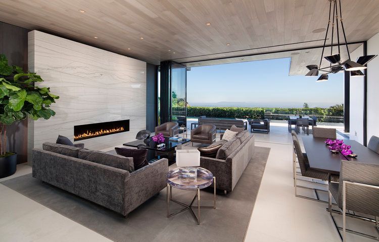 A living room with a fireplace and a dining table
